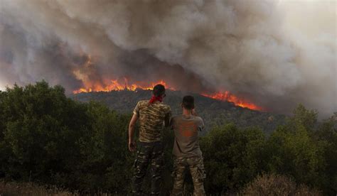 Major wildfires sweeping through forests in Greece force evacuations near Athens and the northeast